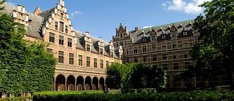 Historic courtyard of the University of Antwerp campus in Belgium, featuring Flemish Renaissance architecture and ivy-covered brick buildings.